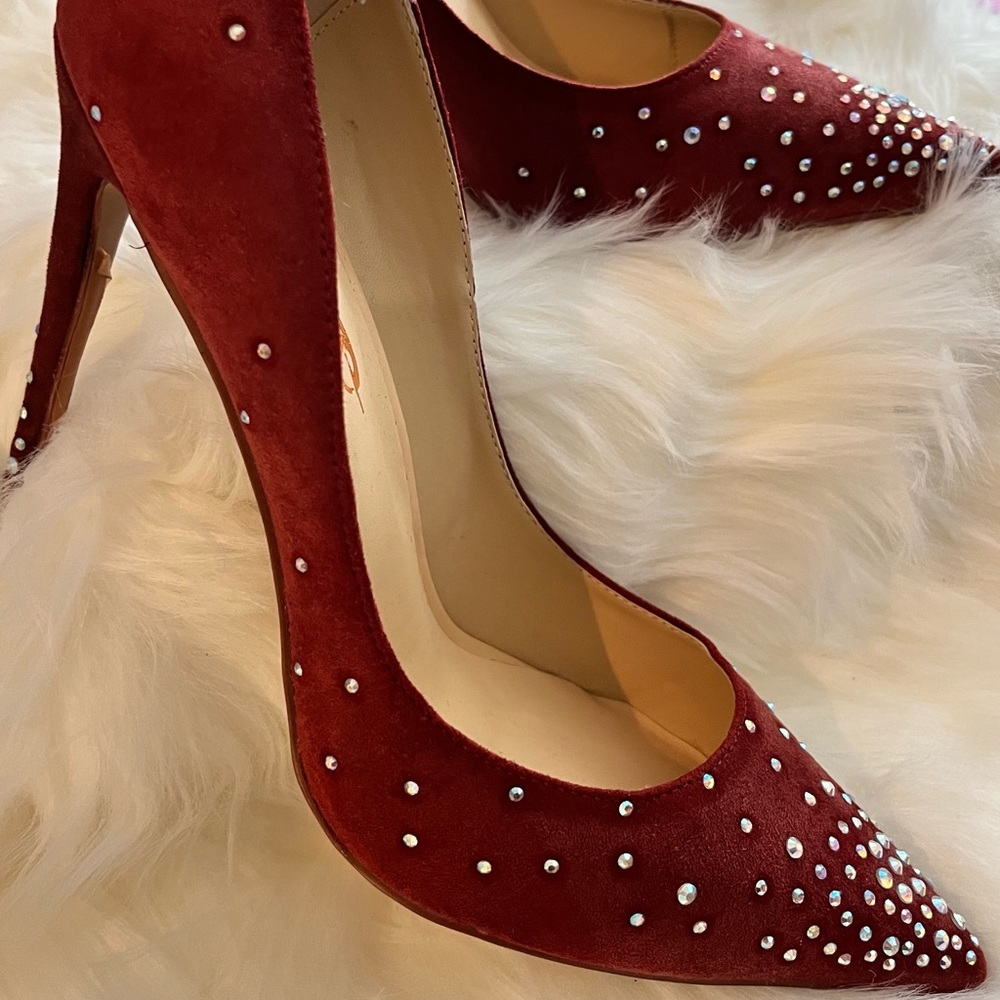 Burgundy stilettos with rhinestones on them
